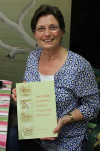 Judith Nissen holding her book cover